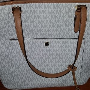 Large leather,top zipper tote.Small pocket infront